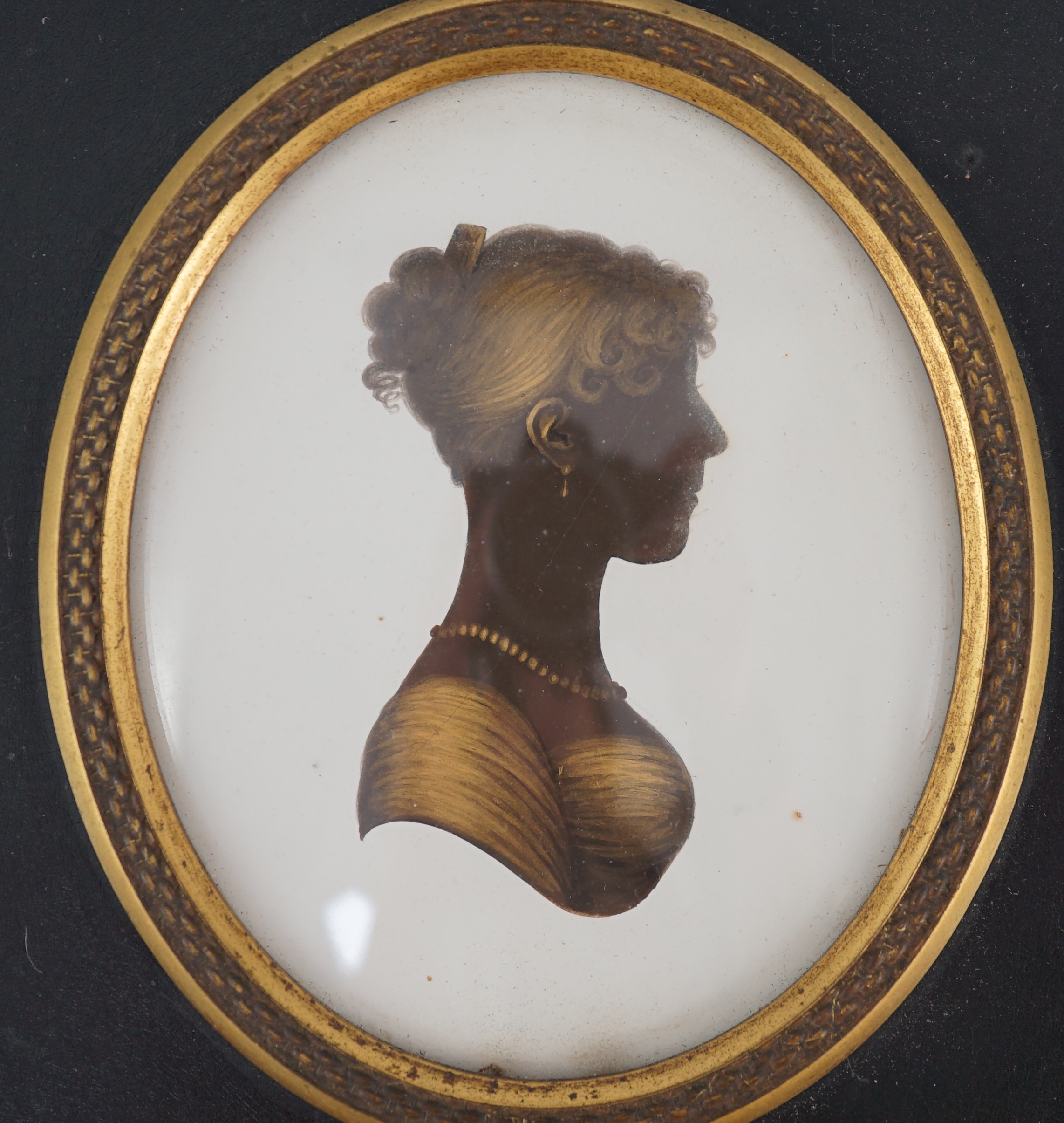 John Miers (1756-1821), Silhouette of a young lady, painted and bronzed plaster, 8 x 6.8cm.